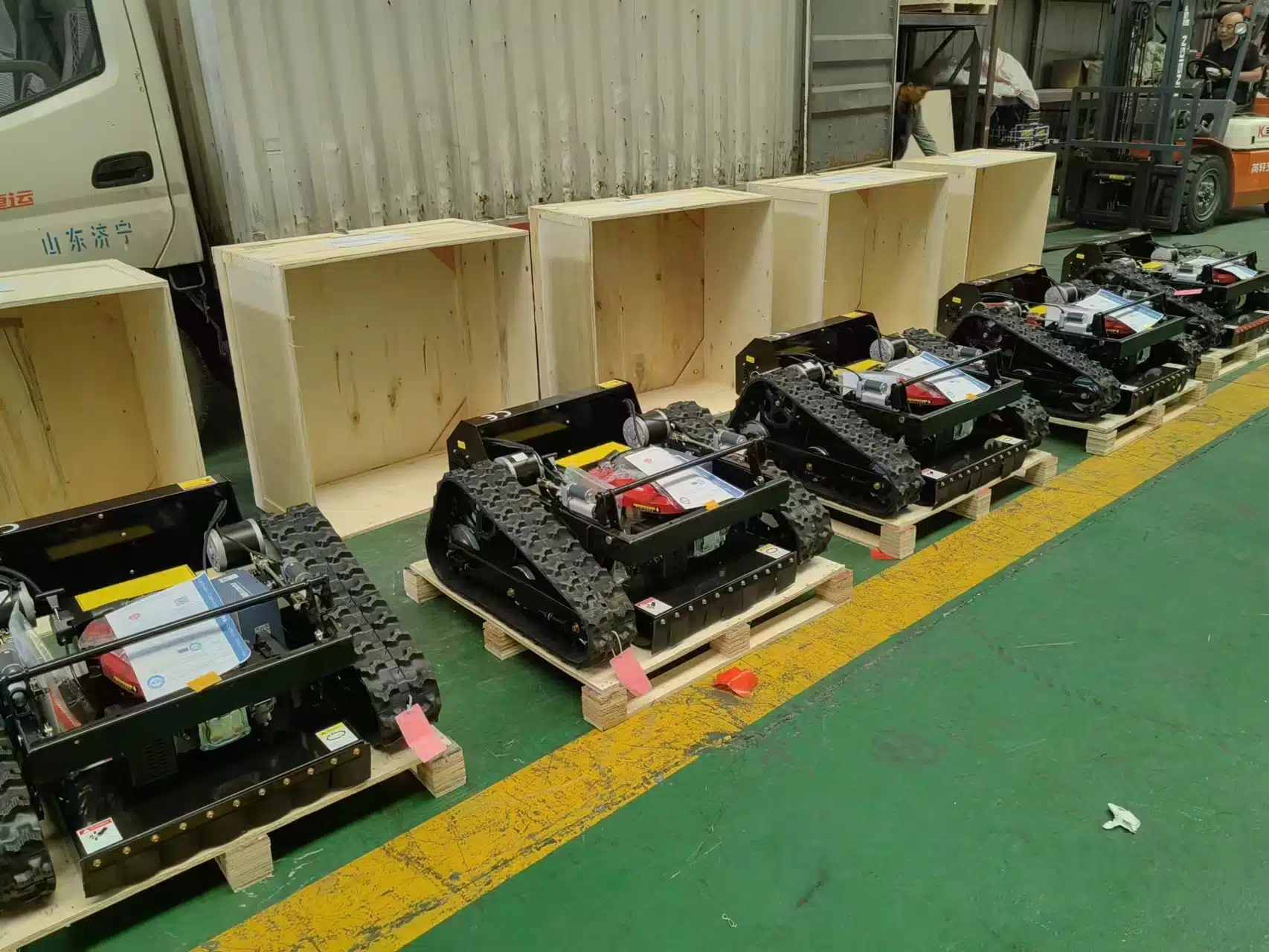 Robotic track vehicles assembled in industrial warehouse