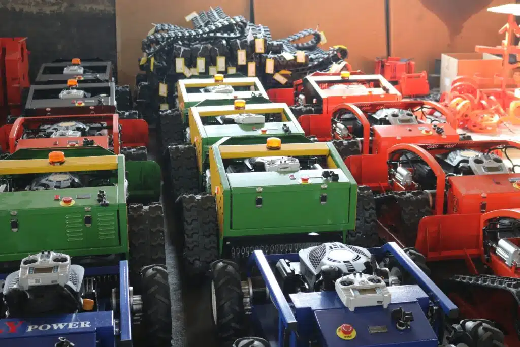 Assortment of colorful agricultural machinery in warehouse