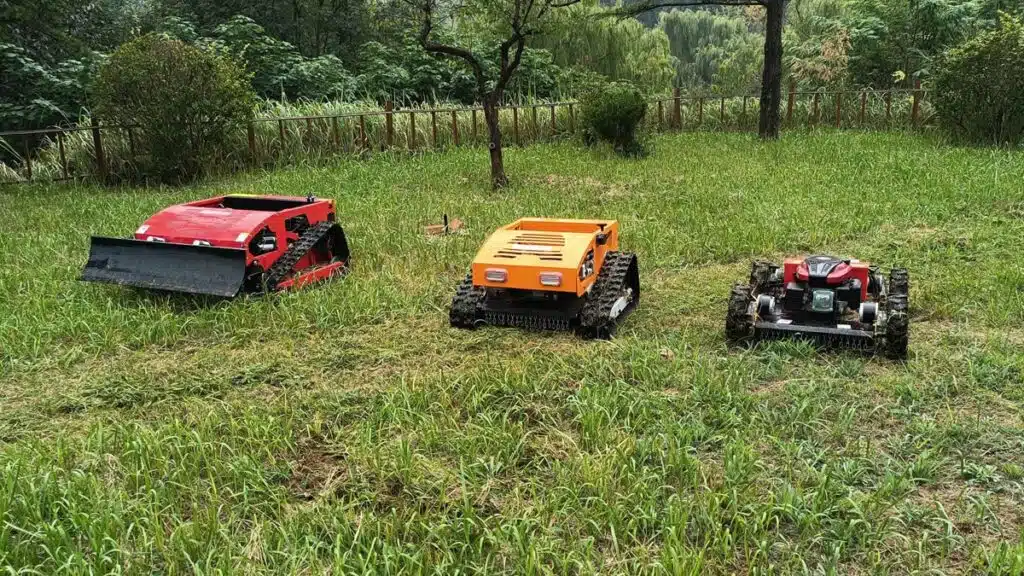 Three robotic mowers on grass
