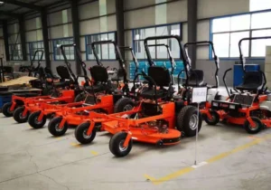Array of new orange zero-turn lawnmowers in warehouse